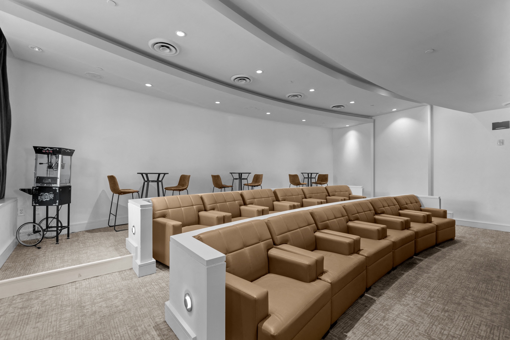 a large lecture hall with a large seating area and a table with chairs